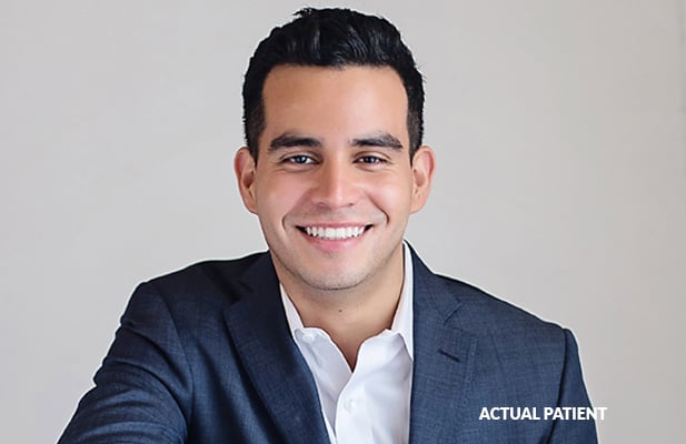 An adult Tisseront Orthodontics patient smiles after straightening his teeth with Adult Braces