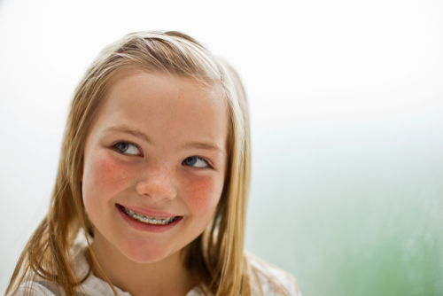 Image of young blonde girl wearing braces.